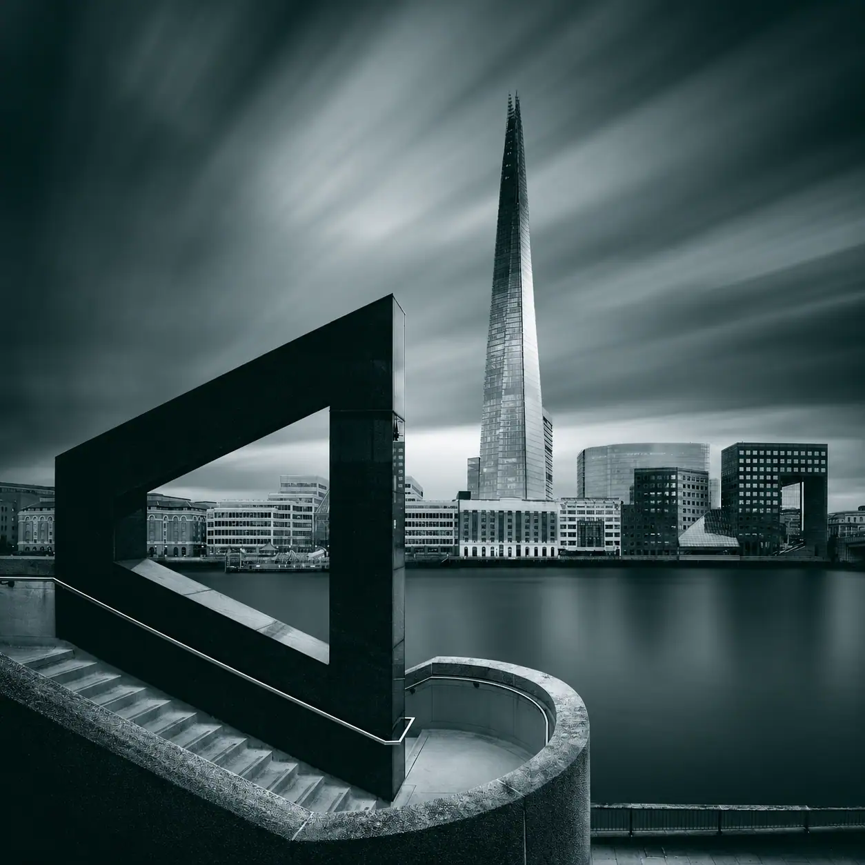 The Shard and London riverfront framed by monumental architecture.