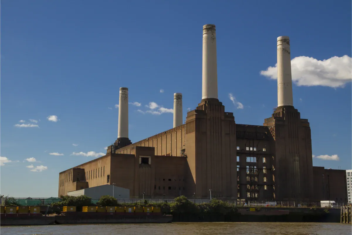Battersea Power Station in London beneath a blue sky.