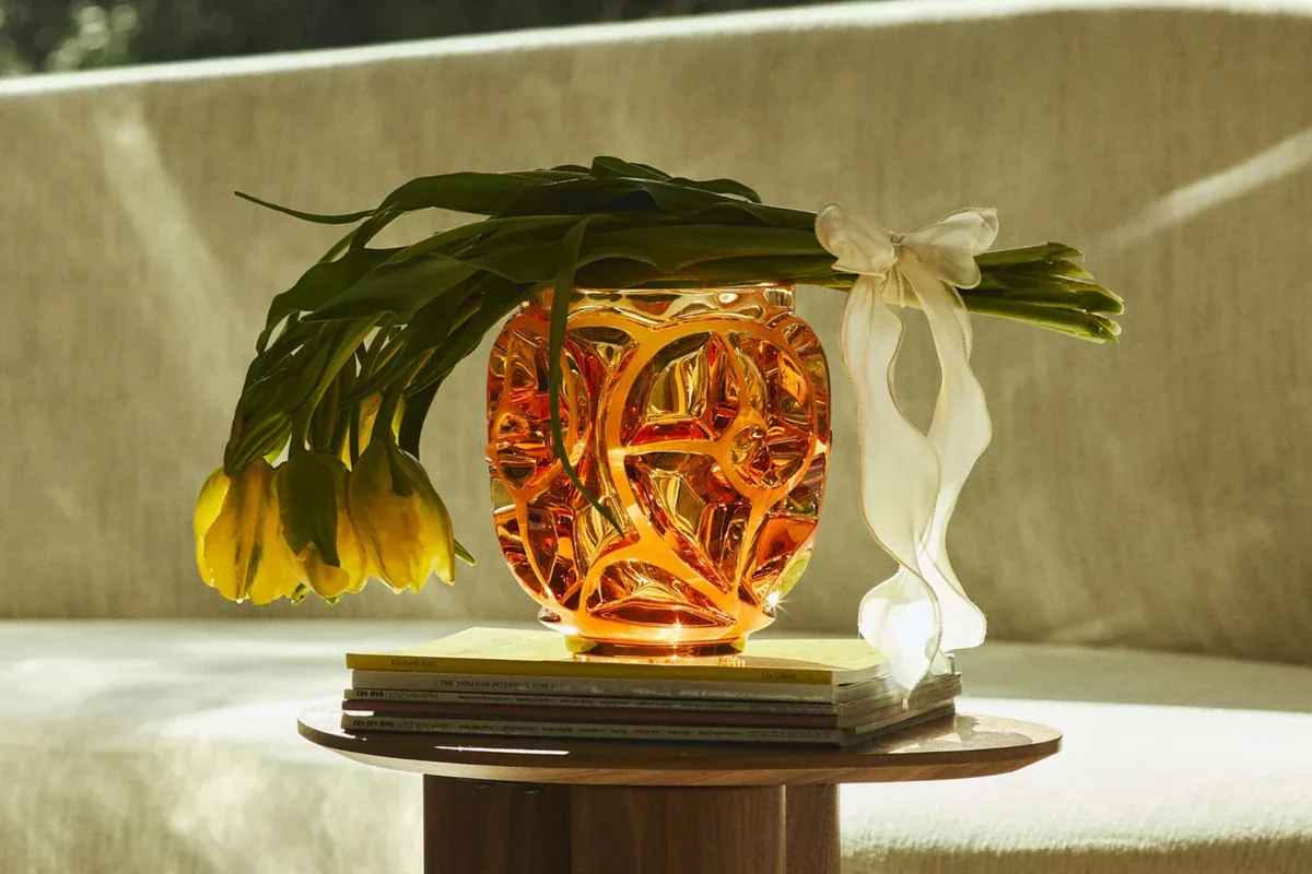 Decorative arrangement of citrus fruit, foliage and sculptural objects.
